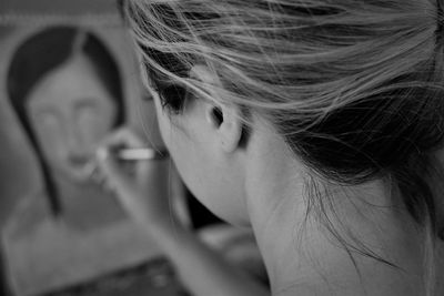 Close-up of woman painting on canvas