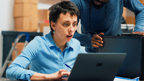 Young woman using laptop at home