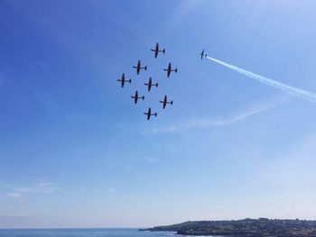 Low angle view of airshow against sky