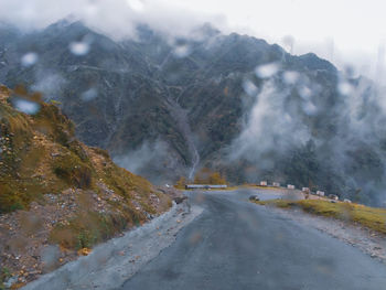 Road amidst mountains during winter