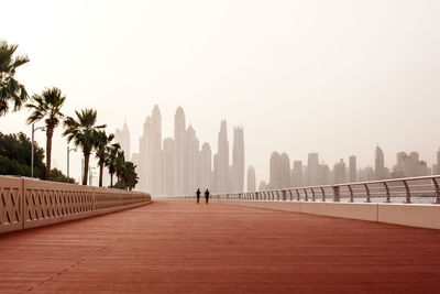 Morning run, a man and a woman run along the road with a beautiful view of dubai. uae