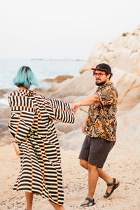 Friends standing at beach