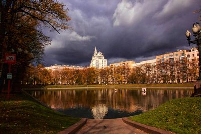 Canal amidst buildings against sky