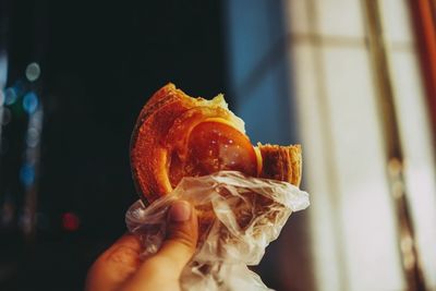 Close-up of hand holding eaten puff pastry