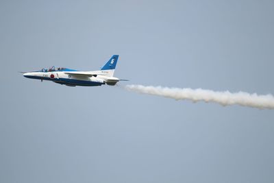 Low angle view of airplane flying against clear sky