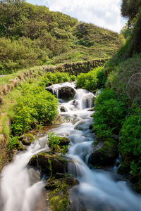 Long exposure of a waterfall flowing onto lee abbey beach in devon