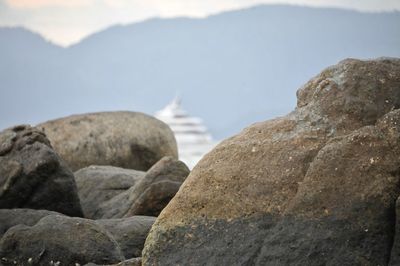 Close-up of rocks on beach against sky