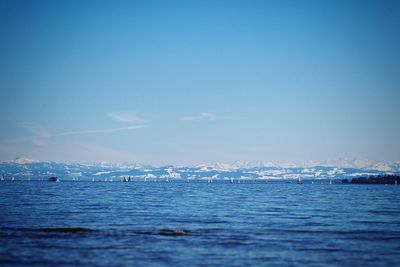 Scenic view of sea against clear blue sky