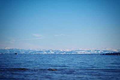 Scenic view of sea against clear blue sky