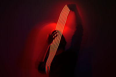 Close-up of guitar against black background