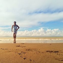 Full length of man on beach against sky