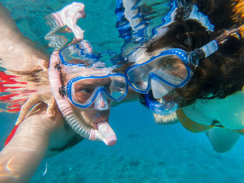 Couple snorkeling in sea