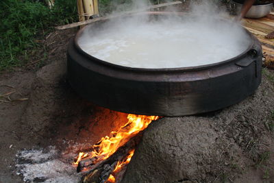 High angle view of food in container on fire pit