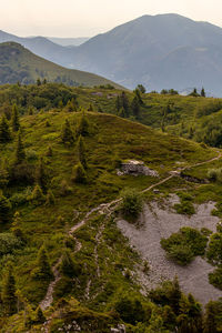 Scenic view of land and mountains against sky