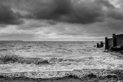 Scenic view of sea against storm clouds