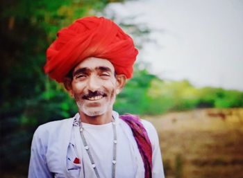 Portrait of smiling man standing on field