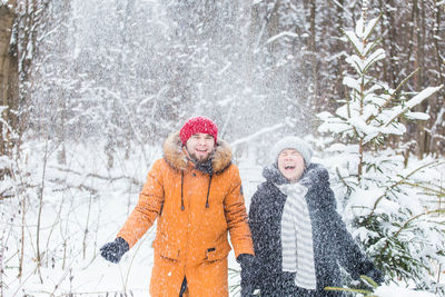 Woman with arms raised in snow