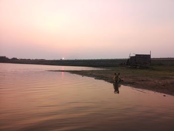 Scenic view of lake against sky during sunset