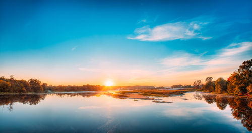 Scenic view of lake against sky during sunset