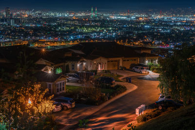 High angle view of illuminated buildings in city at night