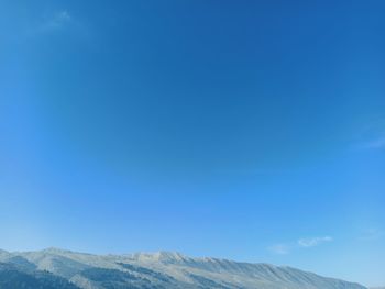 Low angle view of mountain against blue sky