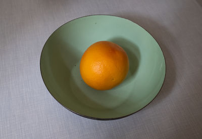 High angle view of orange fruit in bowl on table