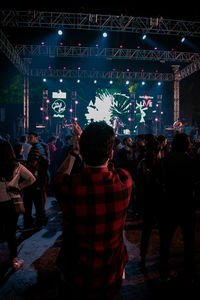 Rear view of people enjoying at music concert