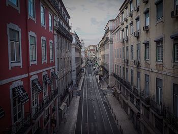 Street amidst buildings in city against sky