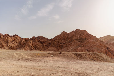 A road next to a mountainous desert landscape. road 12 on the way to eilat, israel, on the egyptian