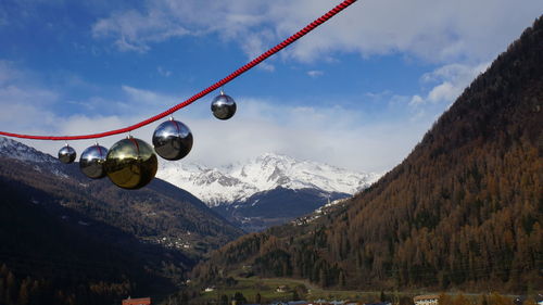 Low angle view of snow covered mountains against sky