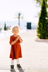 Full length of cute girl standing outdoors