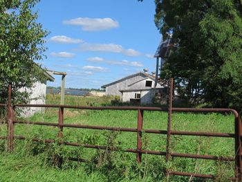 Houses on field against sky