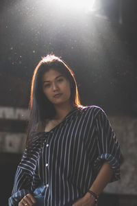 Young woman standing in abandoned building