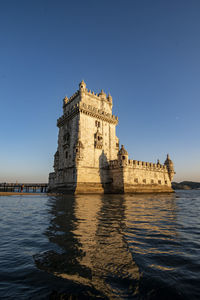 Low angle view of historic building against clear blue sky