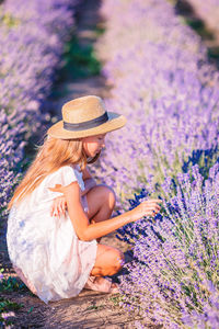 Midsection of woman with purple flowers