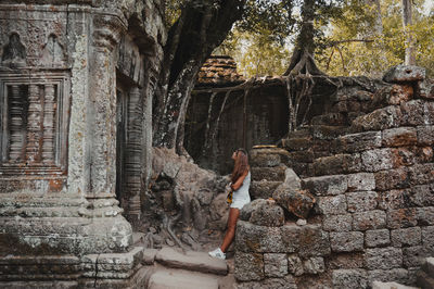 Full length of woman standing by staircase