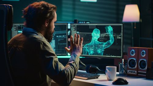 Close-up of man using laptop at office