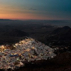 Aerial view of cityscape against sky during sunset