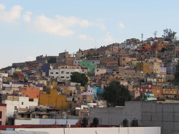 High angle view of buildings in town against sky