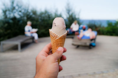 Cropped hand holding ice cream