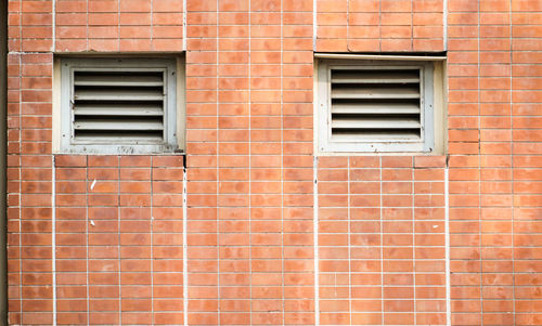 Full frame shot of window on brick wall of building