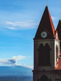 Low angle view of clock tower against sky