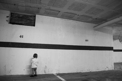 Boy standing against wall