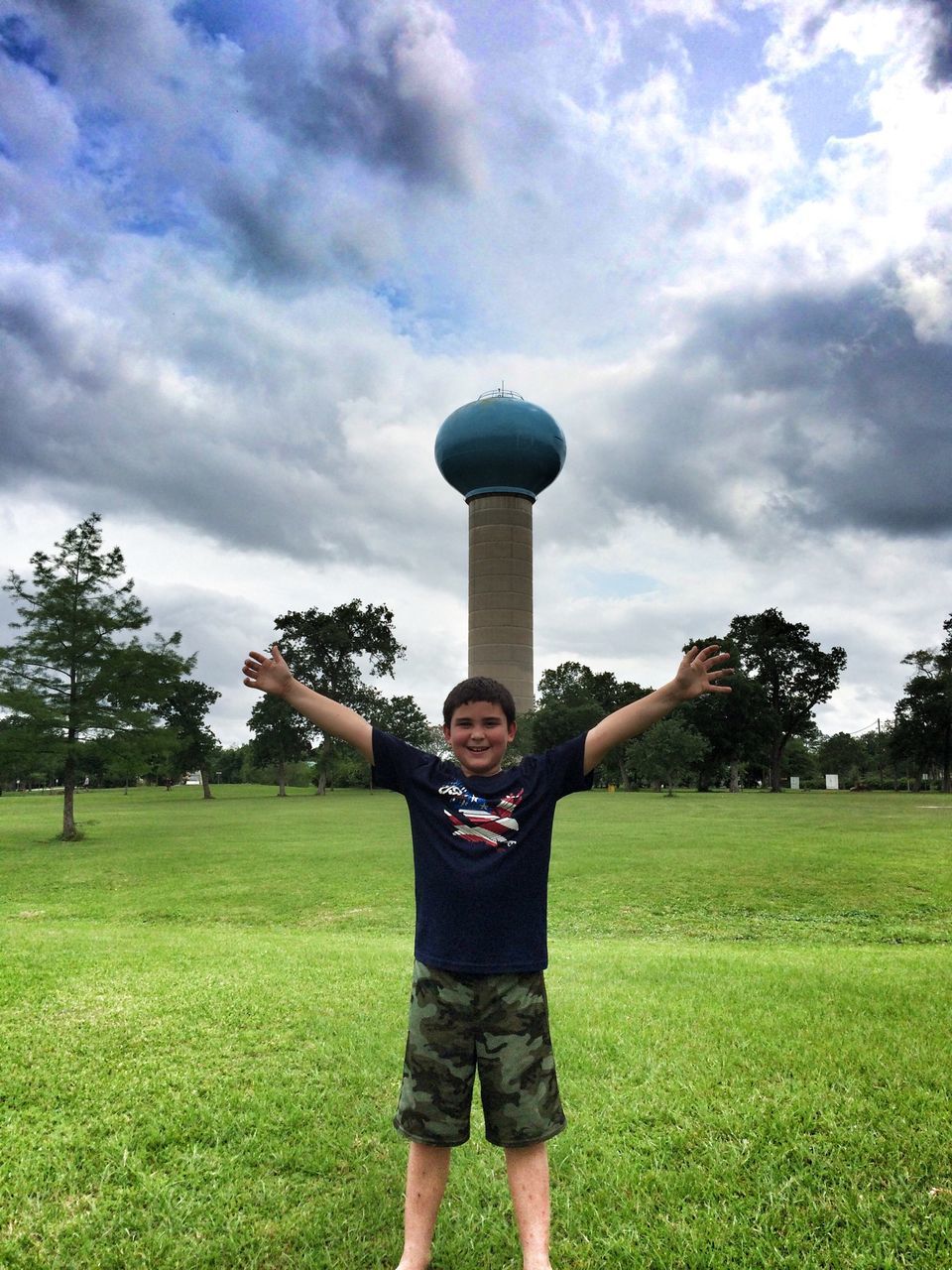 grass, lifestyles, sky, standing, leisure activity, cloud - sky, casual clothing, field, rear view, full length, men, built structure, tree, architecture, building exterior, holding, three quarter length, cloud