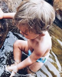 Close-up of shirtless boy in water