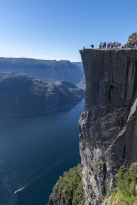 Preikestolen famous tourist attraction in norway. a steep cliff  604 metres above lysefjorden