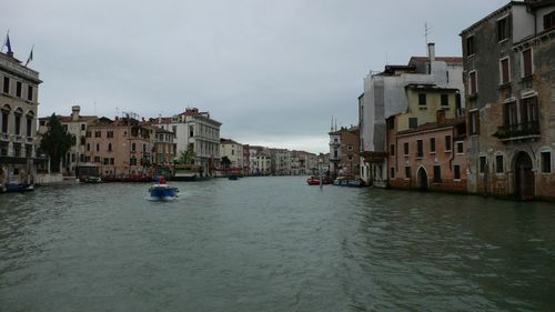 Canal amidst buildings in city