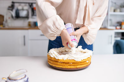 Midsection of woman holding dessert