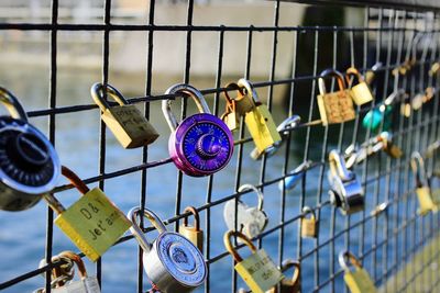 Close-up of padlocks on railing