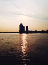 Reflection of buildings in water at sunset